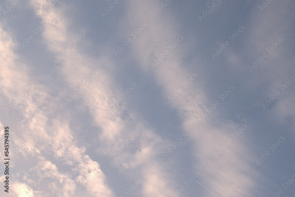 Blue sky on which white clouds and wind painted a picture in the style of abstractionasm