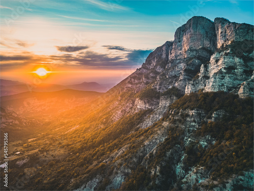 Autumn landscape at Les Trois Becs in Provence Dr  me. Panoramic landscape of the valley during sunset. Limestone rocks covered with trees in autumn colors