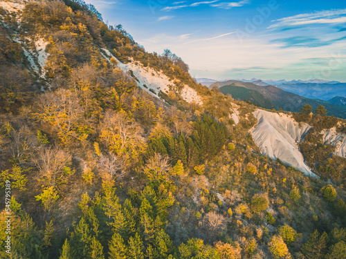 Autumn landscape in Les Trois Becs in Drôme provençale. The top limestone rocks is covered with autumn colors
