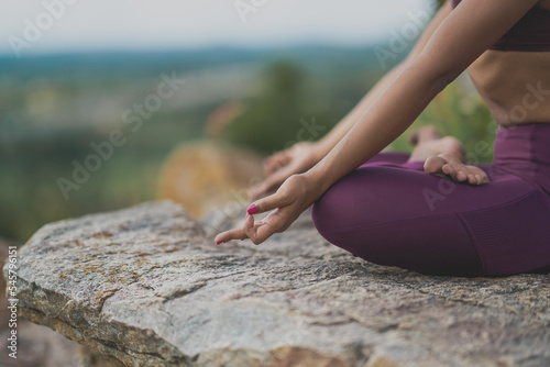 Yogini dancing and practicing yoga outdoors on a mountain in India. Mindful yoga practice. Lotus pose. Meditation. Improvisation. Contemporary dance.