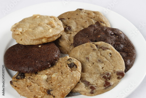 assorted chocolate cookies on a white plate