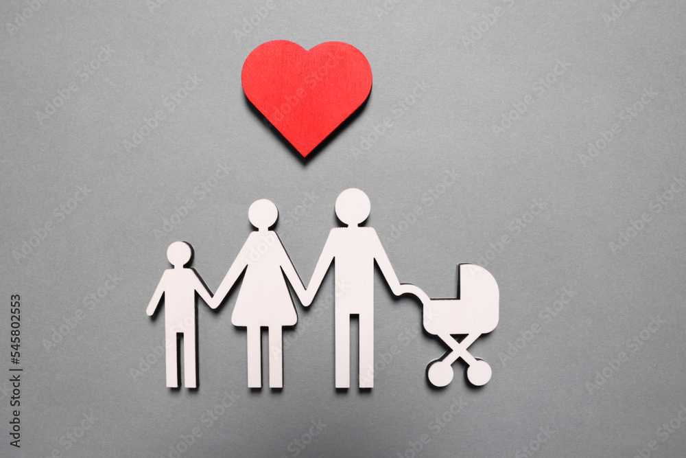 Figures of family under heart on lilac background, top view. Insurance concept Figures of family under heart on lilac background, top view. Insurance concept