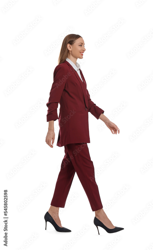 Young woman in burgundy suit walking on white background Young woman in burgundy suit walking on white background