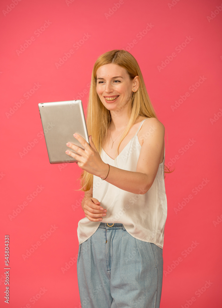 girl uses tablet smartphone isolated.smiling joyful blonde woman with long hair holds a tablet isolated girl uses tablet smartphone isolated.smiling joyful blonde woman with long hair holds a tablet isolated