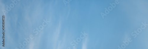 Blue sky background with clouds. Wide panoramic background for design.