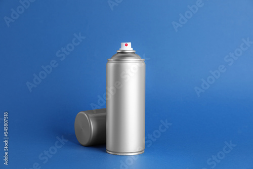 Can of spray paint on blue background