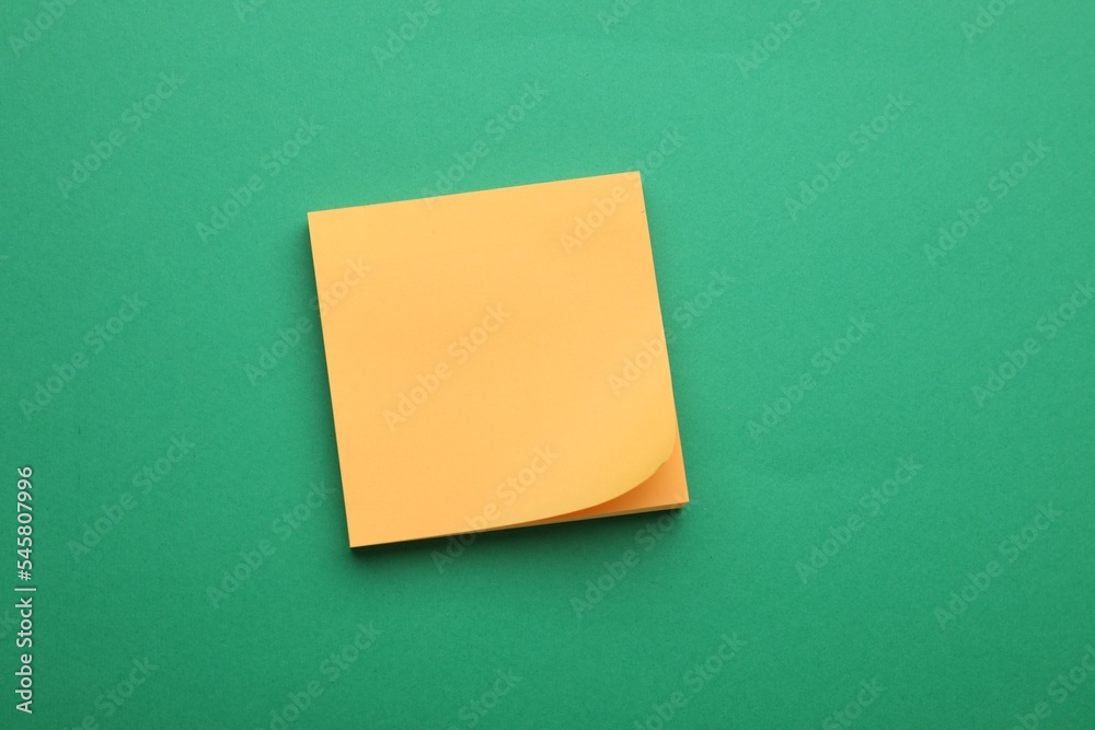 Empty notes on green background, top view. Space for text Empty notes on green background, top view. Space for text