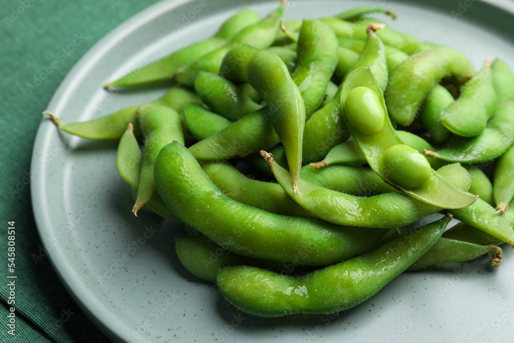 Plate of green edamame beans in pods on table, closeup Plate of green edamame beans in pods on table, closeup