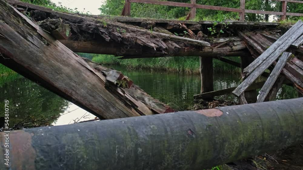 Old Damaged Collapsed Wooden Bridge over Shallow River Old Damaged Collapsed Wooden Bridge over Shallow River