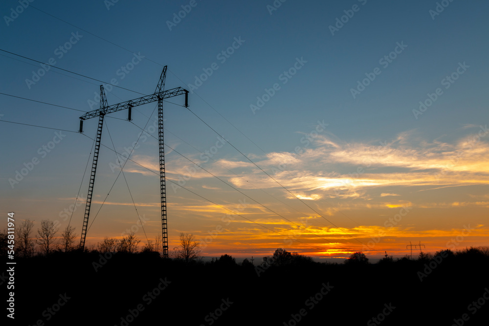 High voltage power lines at sunset.In future - scarcity of electricity. Due to high prices desperate people have no money to pay for electricity