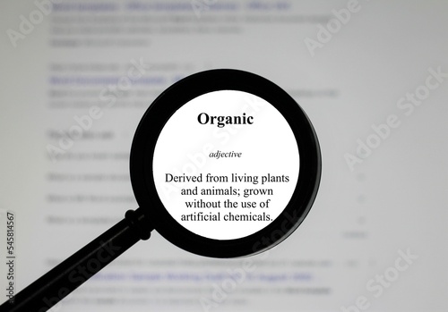 Selective focus on word Organic, word in a dictionary. Close up of an English dictionary page with word organic.