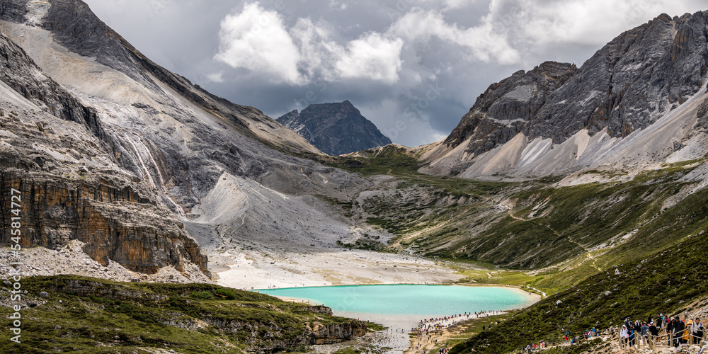 Panorama of the Milk lake at Doacheng Yading National park, Sichuan, China. Last Shangri-la hight 4,600 meter from sea level. It’s beautiful place field, Snow mountain, Lake, dramatic sky