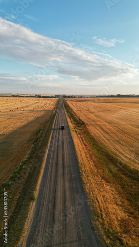 Drone view during sunrise over a farm hay field and river in Alberta Canada