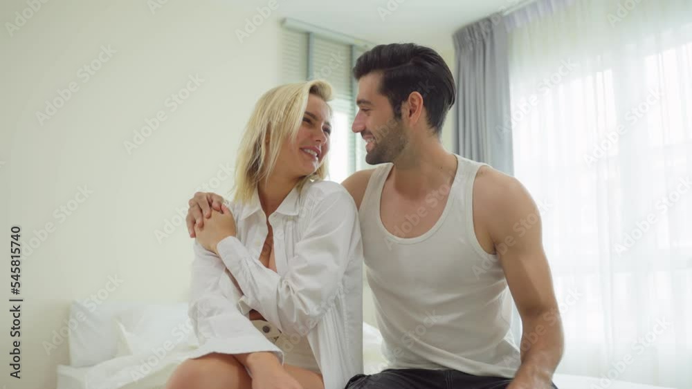 Caucasian beautiful couple spend free leisure time together in bedroom. Caucasian beautiful couple spend free leisure time together in bedroom.