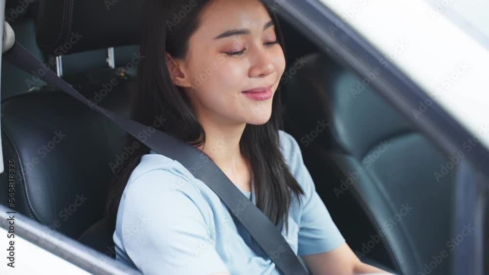 Asian beautiful woman driver fastening seatbelt in car before driving. Asian beautiful woman driver fastening seatbelt in car before driving.