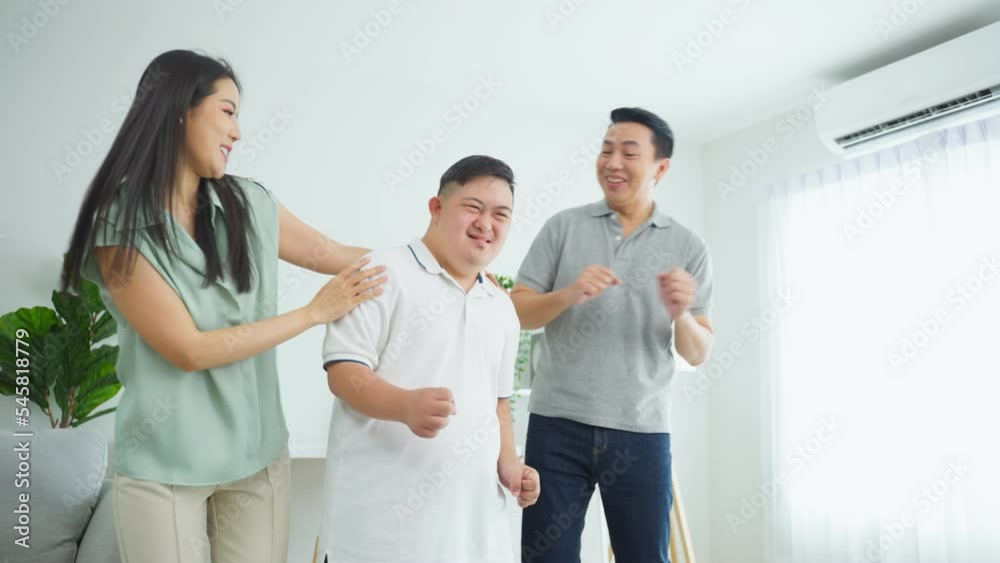 Asian attractive family dancing with young son in living room in house Asian attractive family dancing with young son in living room in house