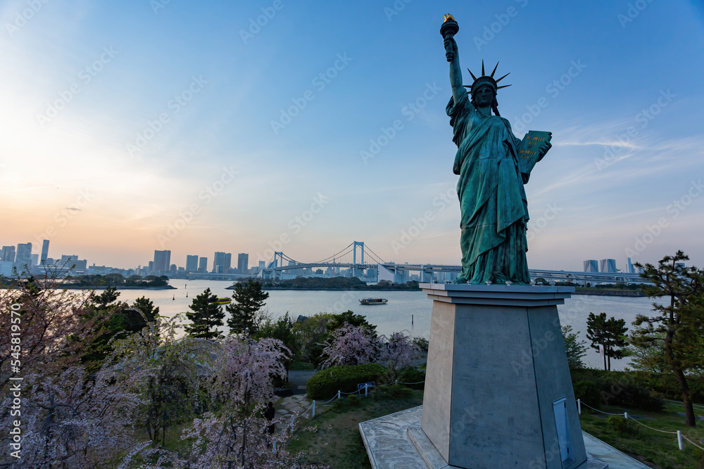 Sunny view of the Rainbow Bridge and Odaiba Statue of Liberty