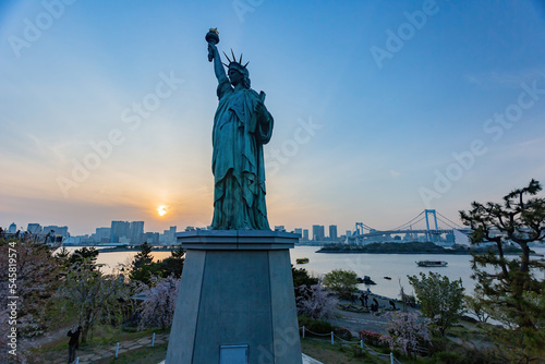 Sunny view of the Rainbow Bridge and Odaiba Statue of Liberty