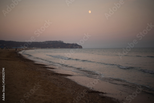 Amazing combination of beach sea and crescent moon.Crescent moon over the sea. Great view away from the city to relax. Amazing skyline.