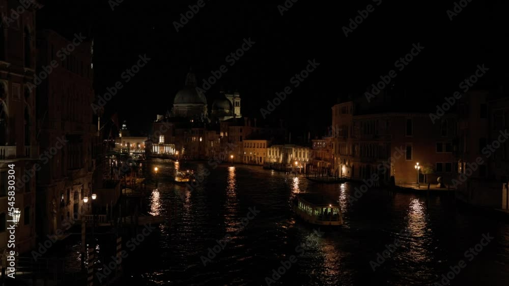 City Lights Reflection On The Grand Canal Passageway During Evening In Venice, Italy. Wide High Angle City Lights Reflection On The Grand Canal Passageway During Evening In Venice, Italy. Wide High Angle