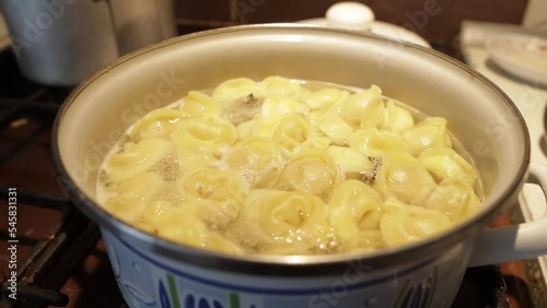 Dumplings are boiled in a saucepan in boiling water.