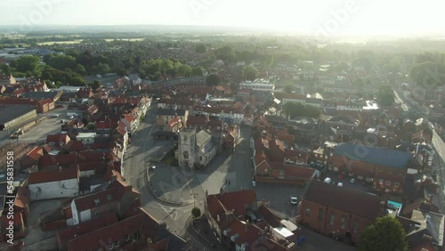 Sunrise drone view over historic market town in England showing village church photo