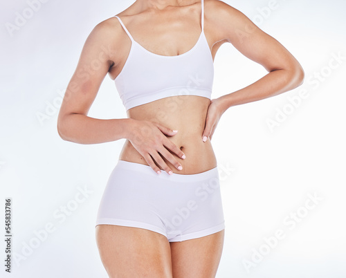 Body, health and fitness with stomach and wellness, body care motivation against white studio background. Slim, exercise and skincare, model in underwear, healthy skin and diet mockup with treatment.