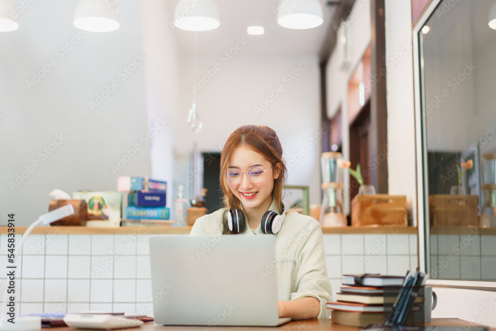 Remote work concept, Woman entrepreneur typing data and working on laptop in coworking space Remote work concept, Woman entrepreneur typing data and working on laptop in coworking space