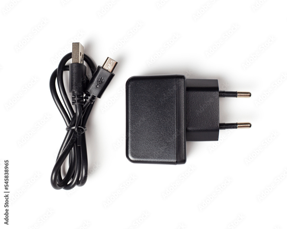 Black charger on a white background, top view. Charger adapter and micro usb cable. Black charger on a white background, top view. Charger adapter and micro usb cable.