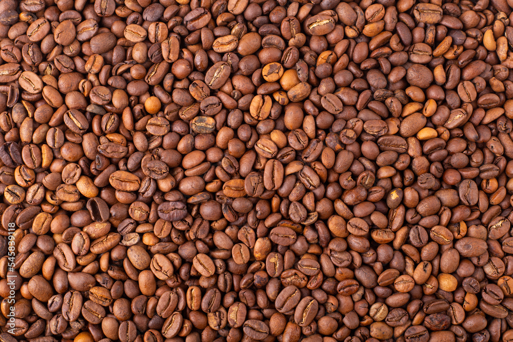 Coffee beans background. Fresh coffee beans, top view. Arabica and Robusta grains. Texture, wallpaper. Coffee beans background. Fresh coffee beans, top view. Arabica and Robusta grains. Texture, wallpaper.