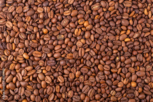 Coffee beans background. Fresh coffee beans, top view. Arabica and Robusta grains. Texture, wallpaper.