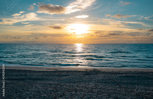 Sunset in the sea with beautiful clouds. Sunrise sea on tropical beach. Landscape of beautiful beach. Beautiful sunset at sea. Ocean sunset on sky background with colorful clouds.