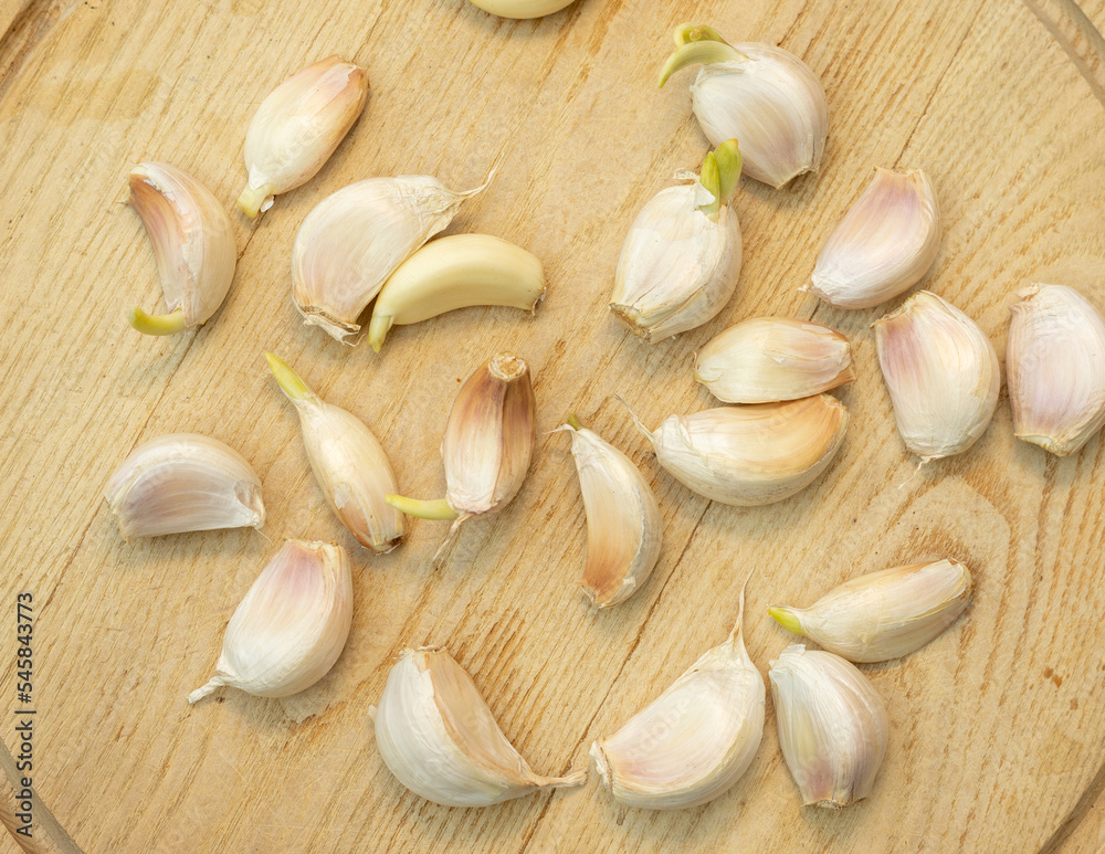Fresh garlic cloves on a wooden background
