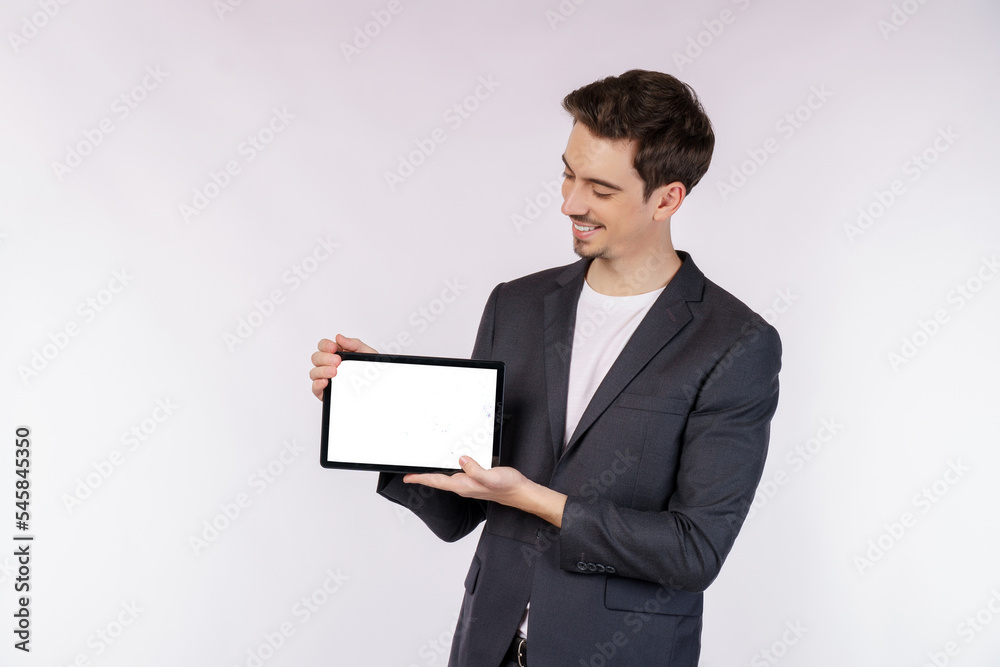 Portrait of attractive cheerful businessman using device app searching web isolated over white color background Portrait of attractive cheerful businessman using device app searching web isolated over white color background