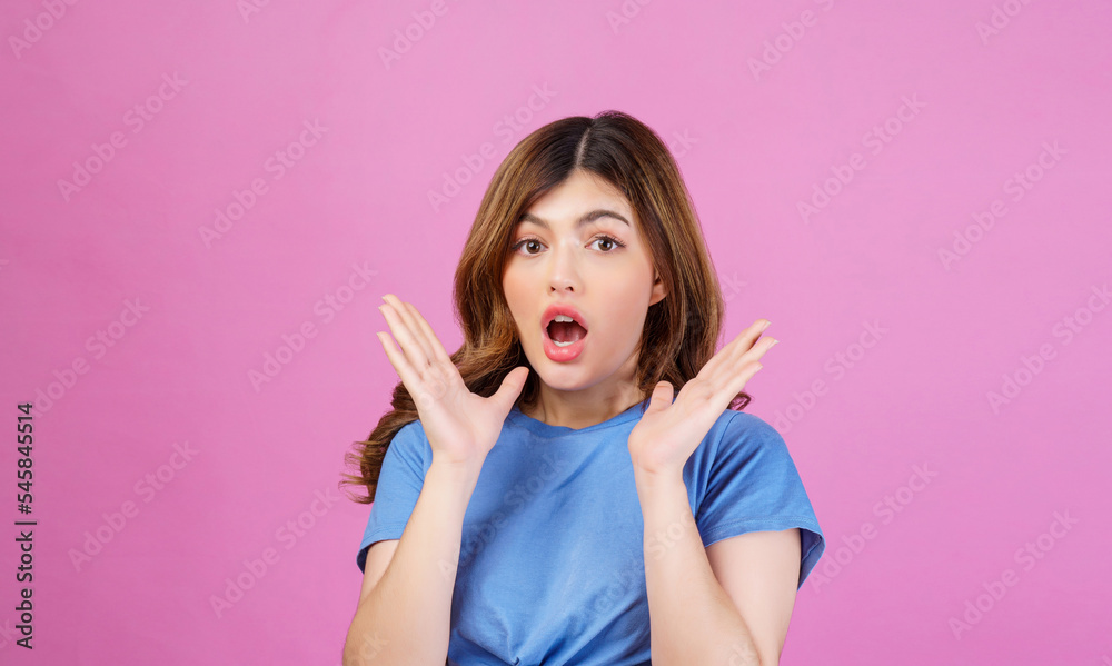 Portrait of excited young woman wearing casual t-shirt surprising isolated over pink background Portrait of excited young woman wearing casual t-shirt surprising isolated over pink background