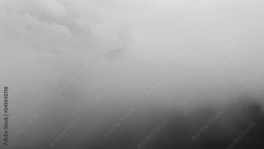 Indonesian nature documentary video. The drone camera moves backwards. past the dark clouds. like an illustration of an airplane flying through the clouds. flight advertisement video. Indonesian nature documentary video. The drone camera moves backwards. past the dark clouds. like an illustration of an airplane flying through the clouds. flight advertisement video.