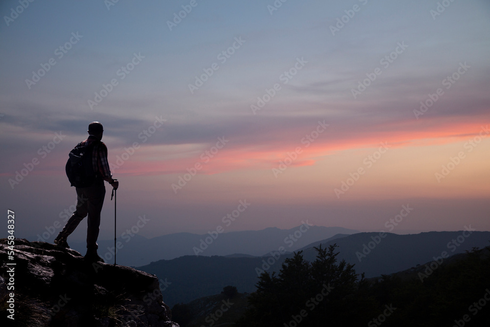 hiker on the mountain summit at sunset in the Matese park
