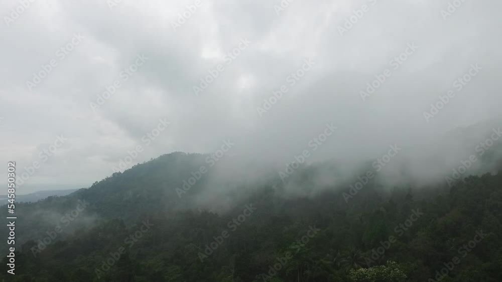 Indonesian nature documentary video. The camera drone moves from bottom to top. Through the thick fog above the height of the mountain peaks and forests of Indonesia. Indonesian nature documentary video. The camera drone moves from bottom to top. Through the thick fog above the height of the mountain peaks and forests of Indonesia.