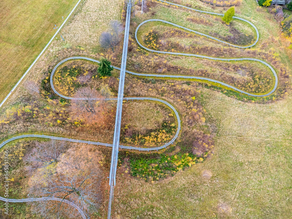 Aerial view of summer bob track in beautiful nature with green mountains in Poland.