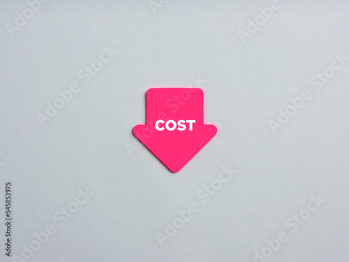 Business costs are falling down or decreasing. Arrow shaped note paper with the word cost.