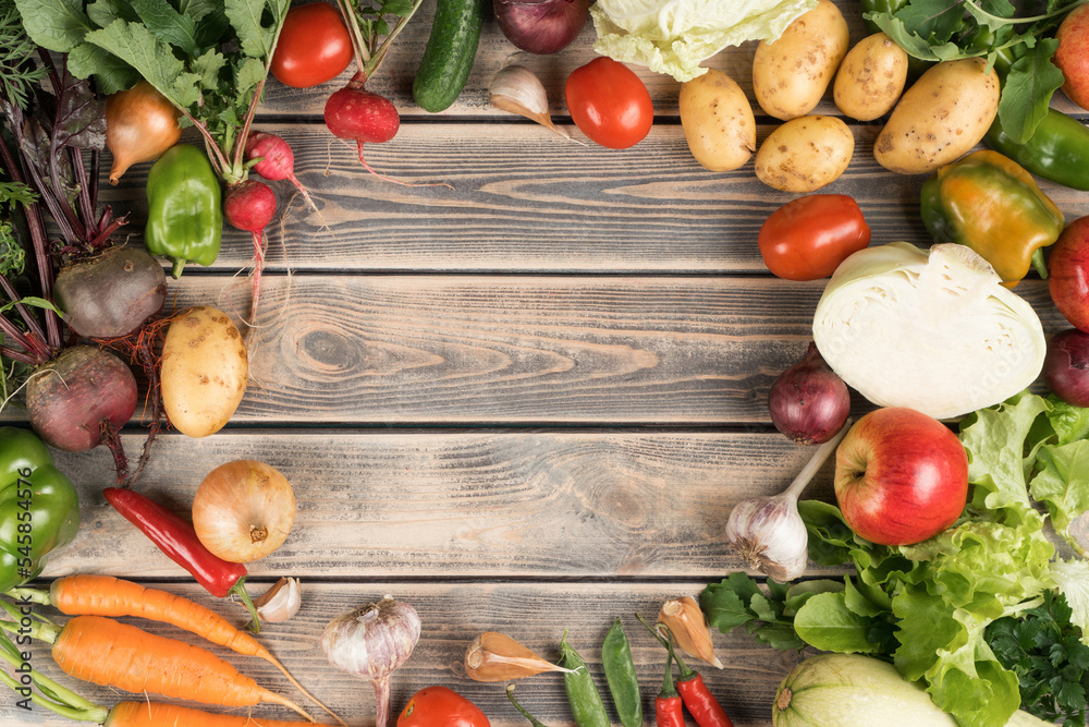 Colorful mix of fresh farm vegetables and fruits, top view. Table full of organic ripe seasonal harvest. Nitrate free food or healthy diet concept. Objects circular arrangement. Cooking ingredients Colorful mix of fresh farm vegetables and fruits, top view. Table full of organic ripe seasonal harvest. Nitrate free food or healthy diet concept. Objects circular arrangement. Cooking ingredients