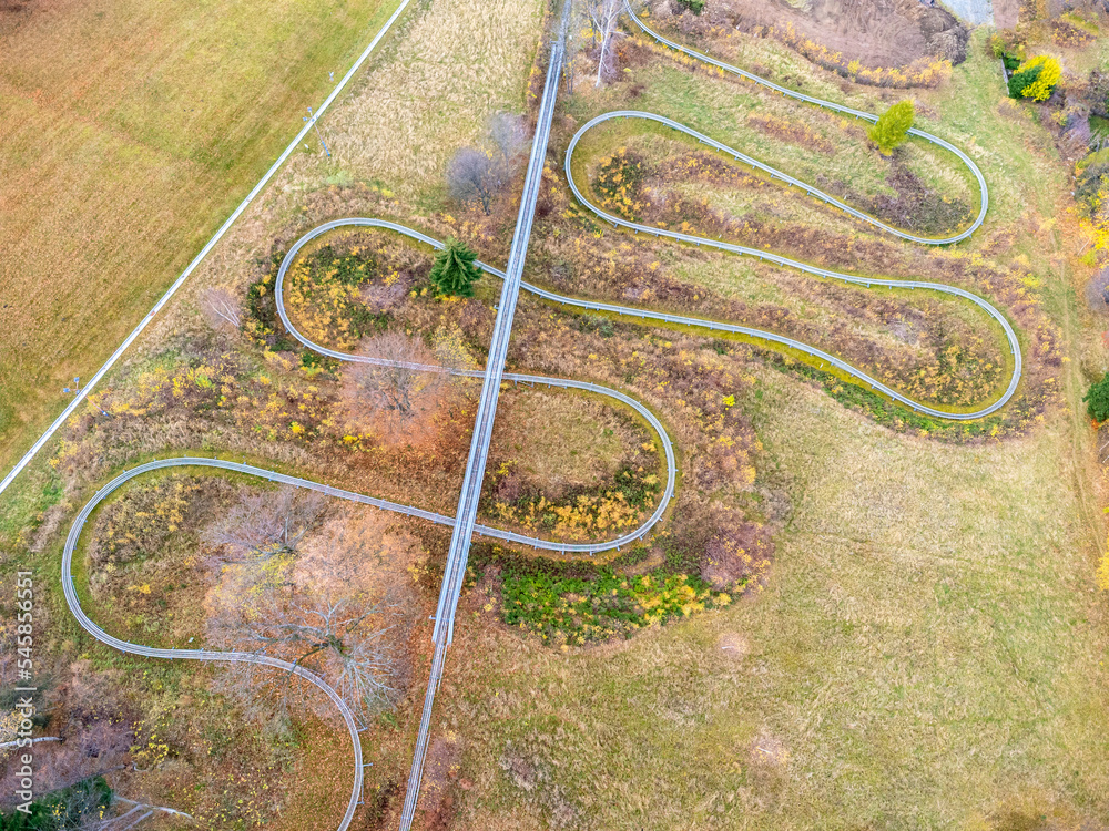 Aerial view of summer bob track in beautiful nature with green mountains in Poland.