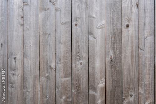 Vertical grey wooden background. Old grey wooden fence texture. Old wood texture background