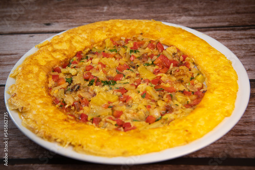 Recipe Omelette with peppers, onions, tomatoes, courgettes and coriander. High quality photo