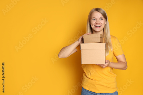 Concept of delivery, surprise, gift, young woman and cardboard boxes © Atlas