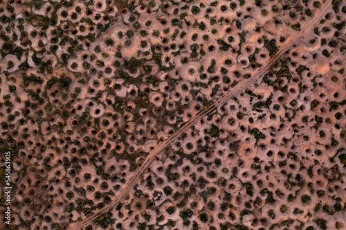 Aerial drone shot abandoned mine shafts in desert landscape