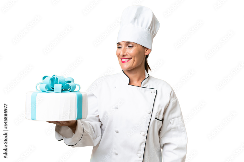 Middle-aged chef caucasian woman with a big cake over isolated background with happy expression Middle-aged chef caucasian woman with a big cake over isolated background with happy expression
