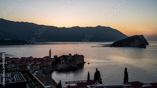 Amazing hyper lapse video of a sunrise over Budva Old town and marina with boats, Montenegro. Hyper lapse from night to day.