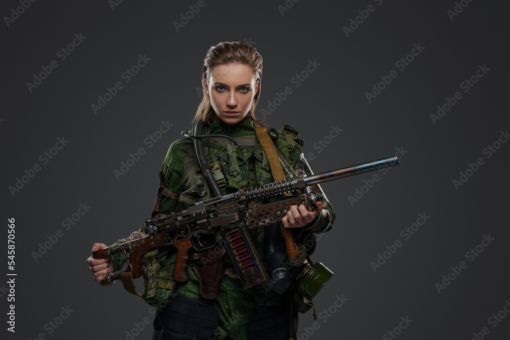 Portrait of female soldier after armageddon with self made shotgun and camouflage uniform Portrait of female soldier after armageddon with self made shotgun and camouflage uniform
