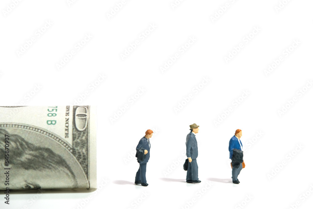 Miniature people toy figure photography. Severance pay for laid off workers concept. Three businessmen with rolled dollar money. Isolated on white background. Miniature people toy figure photography. Severance pay for laid off workers concept. Three businessmen with rolled dollar money. Isolated on white background.